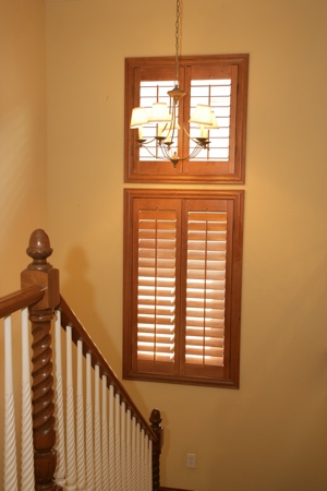 Ovation shutters in tan stairwell.